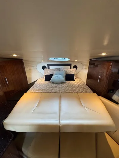 Wine-n-down Yacht Photos Pics 2014 Regal 32 Express cabin interior with bed, wooden cabinets, and ambient lighting.