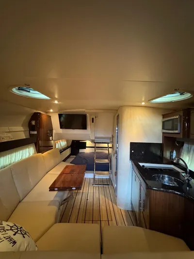 Wine-n-down Yacht Photos Pics 2014 Regal 32 Express interior with kitchen, seating, and wood flooring.