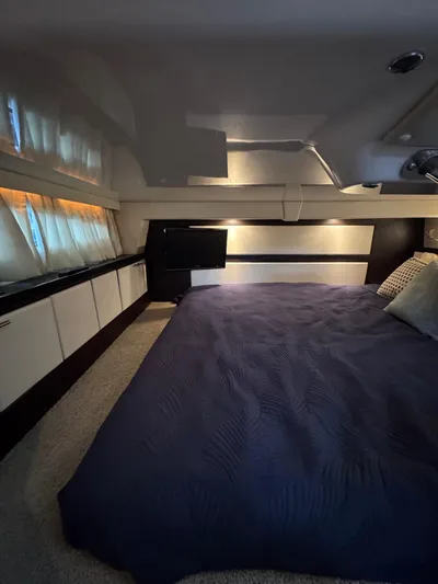 Wine-n-down Yacht Photos Pics 2014 Regal 32 Express cabin interior with bed, modern design, and ambient lighting.