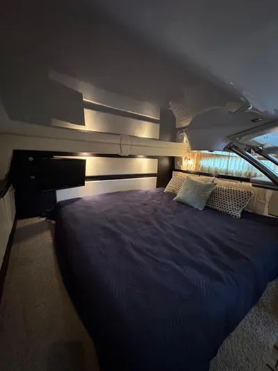 Wine-n-down Yacht Photos Pics Interior cabin of 2014 Regal 32 Express with cozy bedding and modern design.