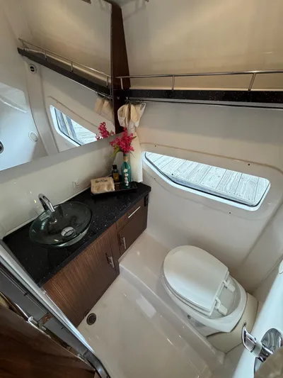 Wine-n-down Yacht Photos Pics 2014 Regal 32 Express yacht bathroom with modern sink, toilet, and window view.