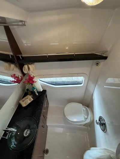 Wine-n-down Yacht Photos Pics Bathroom interior of 2014 Regal 32 Express yacht with modern fixtures and window.