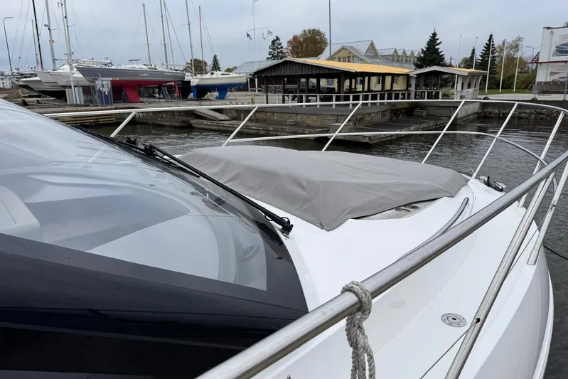  Yacht Photos Pics 2021 Princess F45 yacht docked at marina with covered deck, surrounded by boats.