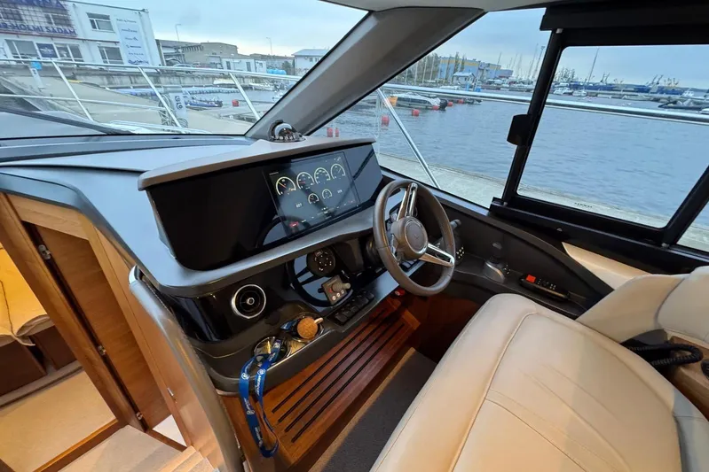  Yacht Photos Pics Luxurious 2021 Princess F45 yacht helm with modern dashboard and leather seating.