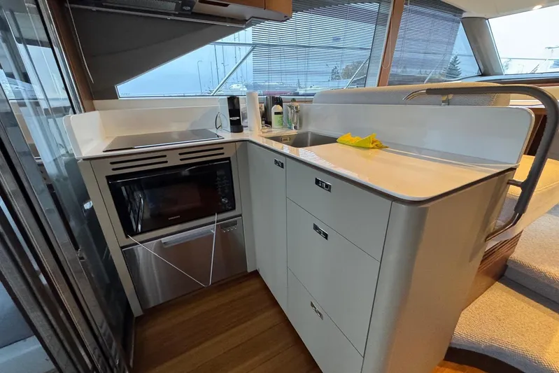  Yacht Photos Pics Modern kitchen interior on 2021 Princess F45 yacht, featuring sleek cabinetry and appliances.