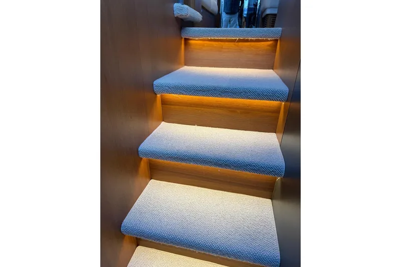  Yacht Photos Pics Illuminated carpeted stairs inside 2021 Princess F45 yacht.