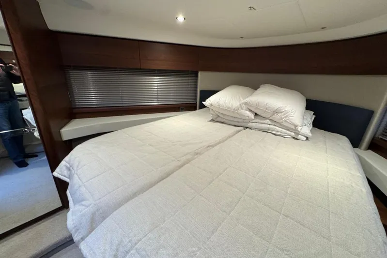  Yacht Photos Pics Luxurious bedroom interior of 2021 Princess F45 yacht with cozy bedding and modern design.