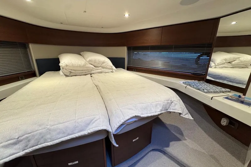  Yacht Photos Pics Luxurious cabin interior of 2021 Princess F45 yacht with cozy bedding and modern design.