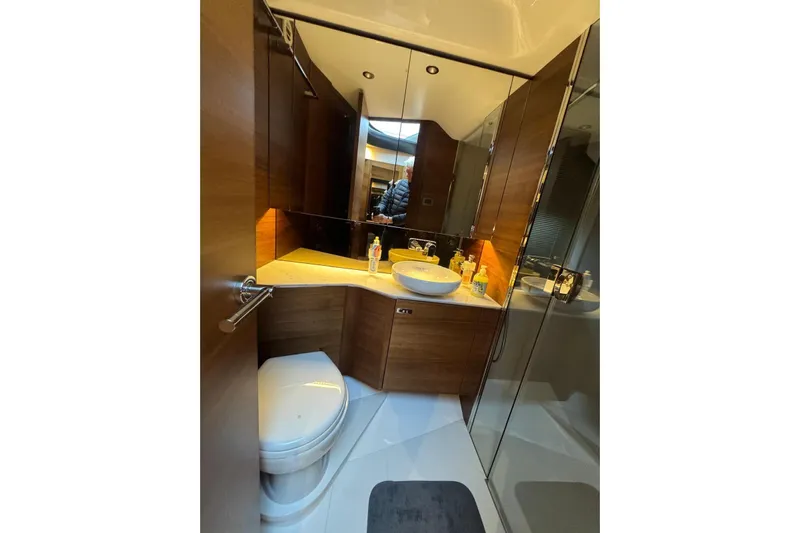  Yacht Photos Pics Luxurious bathroom in 2021 Princess F45 yacht with modern fixtures and wood accents.