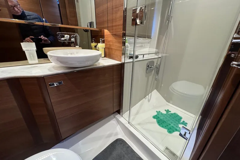  Yacht Photos Pics Luxurious bathroom in 2021 Princess F45 yacht with modern fixtures and glass shower.