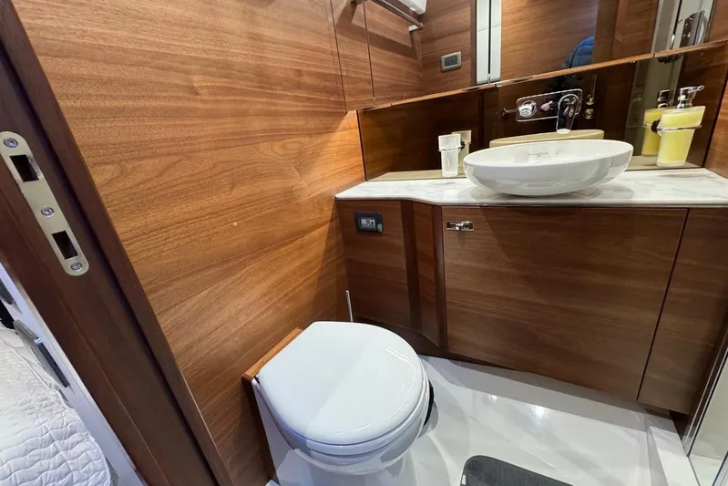  Yacht Photos Pics Luxurious bathroom in 2021 Princess F45 yacht with wood paneling and modern fixtures.