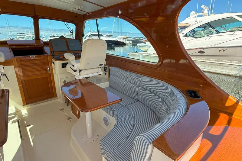 Madeline Kathleen Yacht Photos Pics Interior of 2003 Hinckley Talaria 40 yacht with wood finish and striped seating.
