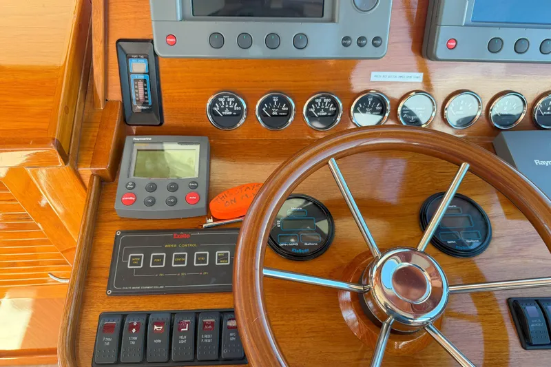 Madeline Kathleen Yacht Photos Pics Hinckley Talaria 40 yacht dashboard with wooden steering wheel and navigation instruments, 2003 model.