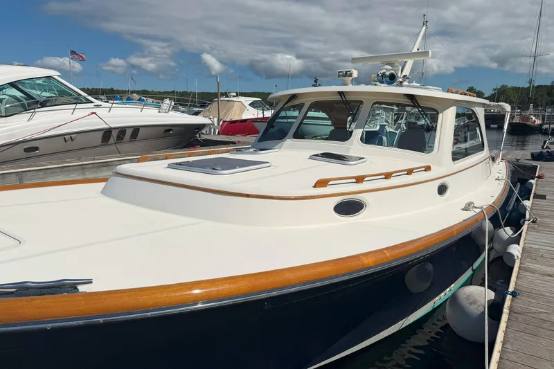 Madeline Kathleen Yacht Photos Pics 2003 Hinckley Talaria 40 yacht docked at marina under cloudy sky.