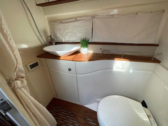  Yacht Photos Pics Bathroom interior of 2015 Sea Ray 350 Sundancer yacht with modern sink and toilet.