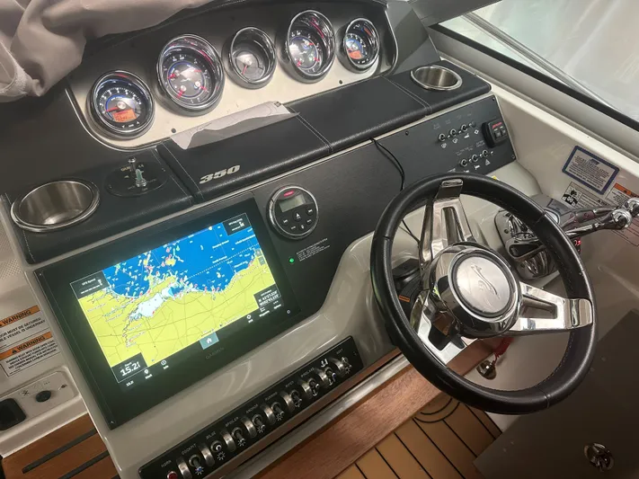  Yacht Photos Pics Cockpit of 2015 Sea Ray 350 Sundancer with navigation display and steering wheel.