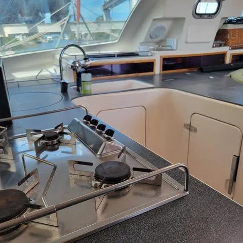 Hazey Daze Yacht Photos Pics Interior of a 2001 Voyage Maxim yacht kitchen with stove and sink.