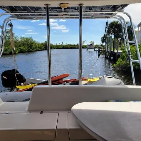 Hazey Daze Yacht Photos Pics Boat deck view of a serene river with lush greenery, Voyage Maxim 2001.