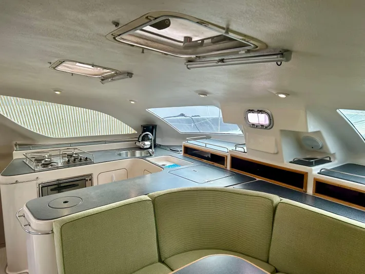 Hazey Daze Yacht Photos Pics Interior of 2001 Voyage Maxim yacht with modern kitchen and seating area.