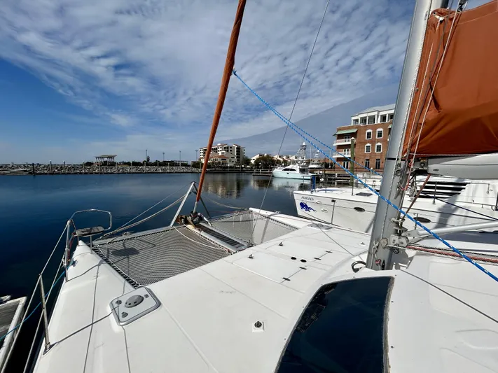 Hazey Daze Yacht Photos Pics Sailboat Voyage Maxim 2001 docked in a marina with clear skies and calm waters.