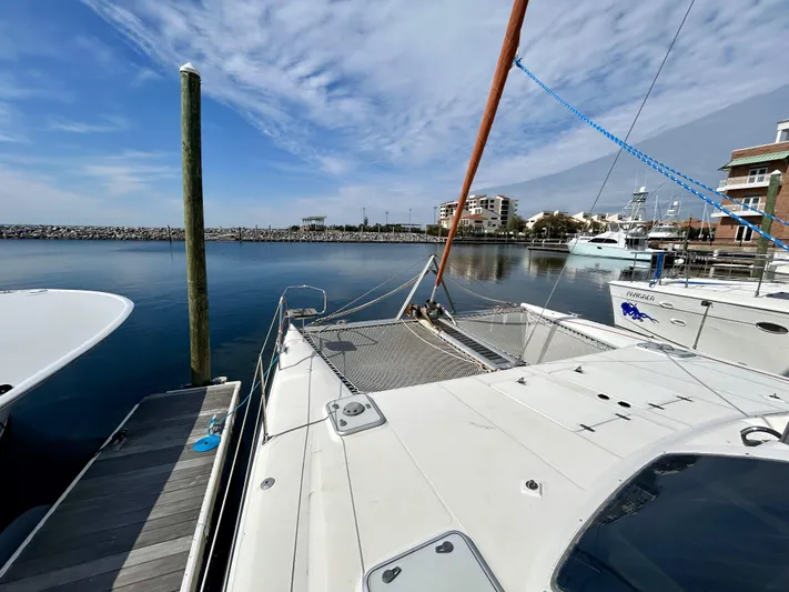 Hazey Daze Yacht Photos Pics 2001 Voyage Maxim catamaran docked at marina with clear blue sky and calm water.