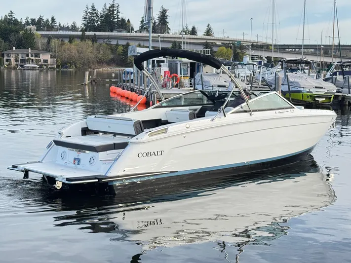  Yacht Photos Pics 2023 Cobalt R8 boat docked on calm water, featuring sleek design and modern amenities.
