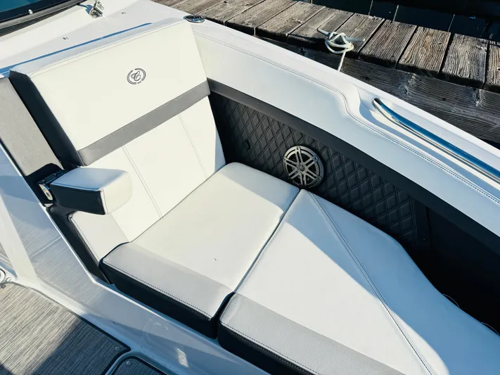  Yacht Photos Pics 2023 Cobalt R8 boat interior with white cushioned seating and speaker detail.