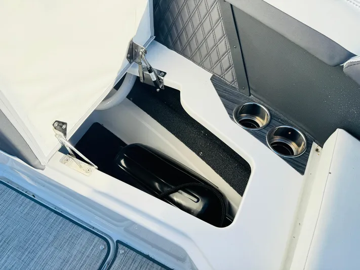  Yacht Photos Pics 2023 Cobalt R8 boat interior storage compartment with cup holders and quilted paneling.