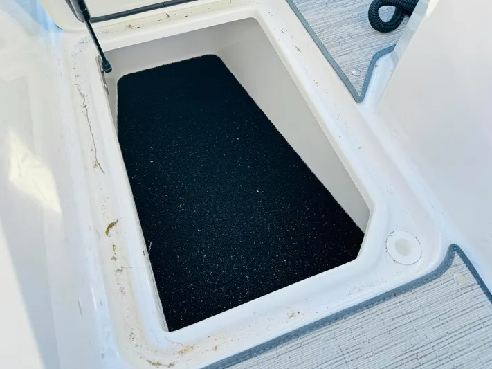  Yacht Photos Pics Storage compartment in 2023 Cobalt R8 boat, featuring a black non-slip surface.