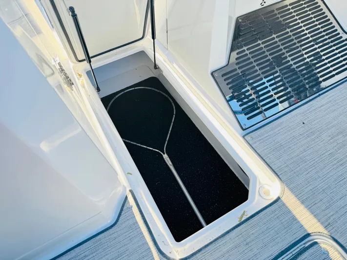  Yacht Photos Pics Open storage compartment on 2023 Cobalt R8 boat with net inside.