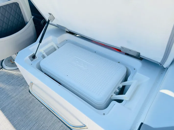  Yacht Photos Pics 2023 Cobalt R8 boat cooler compartment with open lid, showcasing interior storage.