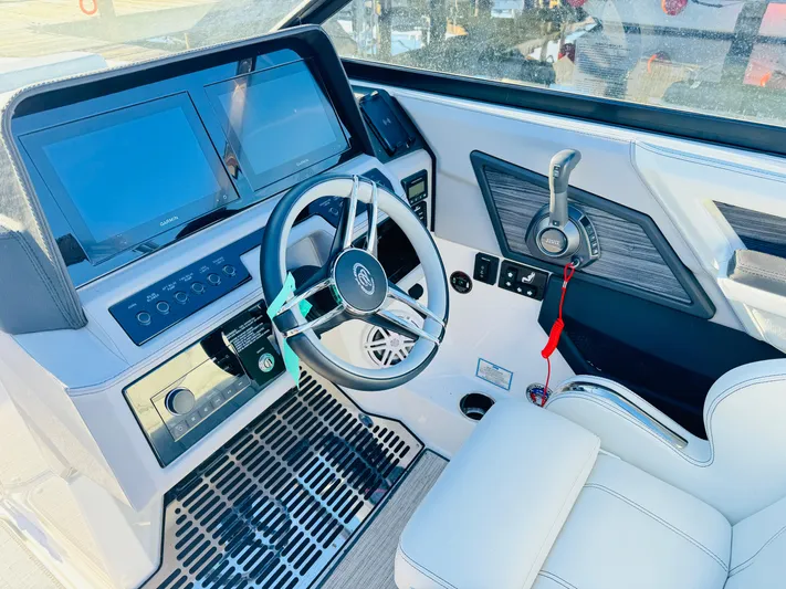  Yacht Photos Pics 2023 Cobalt R8 boat cockpit with modern steering wheel and dual display screens.