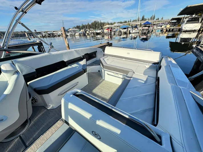  Yacht Photos Pics 2023 Cobalt R8 boat interior with spacious seating at a marina.