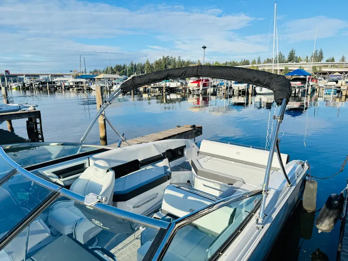  Yacht Photos Pics 2023 Cobalt R8 boat docked at a marina, featuring sleek design and spacious seating.