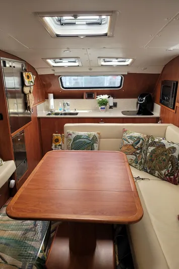 Sea The Light Yacht Photos Pics 2019 Endeavour Catamaran 440 HYBRID interior with kitchen and dining area.