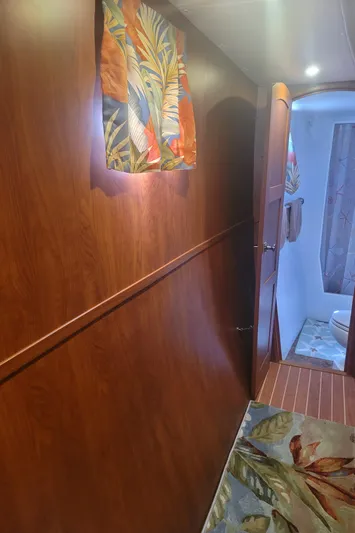 Sea The Light Yacht Photos Pics Interior hallway of 2019 Endeavour Catamaran 440 HYBRID with wooden paneling and tropical decor.