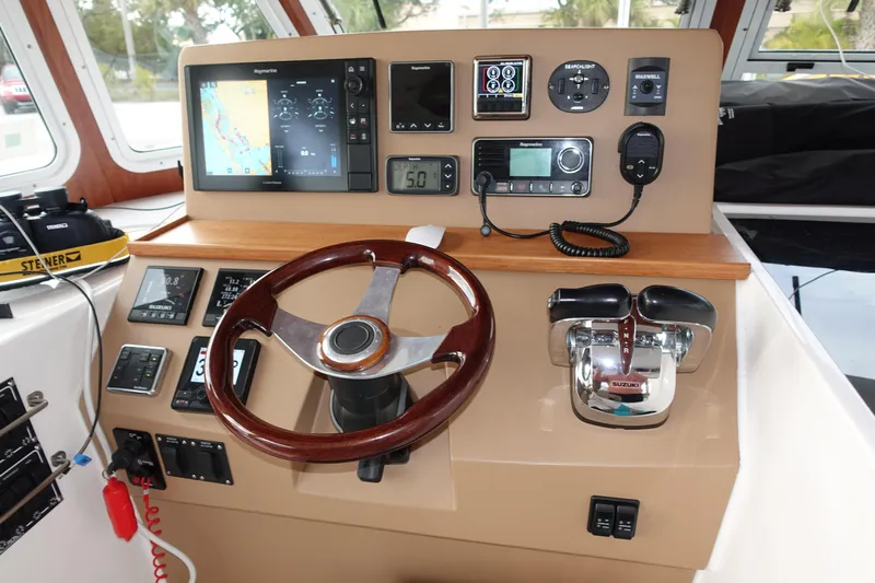 Sea The Light Yacht Photos Pics Helm station of 2019 Endeavour Catamaran 440 HYBRID with navigation equipment and controls.