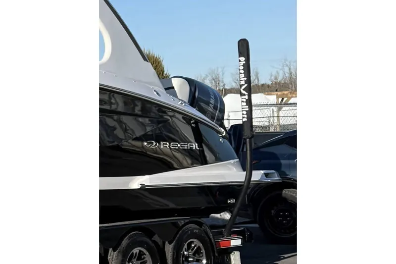  Yacht Photos Pics 2021 Regal 29 OBX boat on trailer, featuring sleek black and silver design.