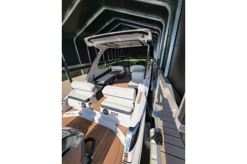  Yacht Photos Pics 2021 Regal 29 OBX boat with spacious seating under a covered dock.