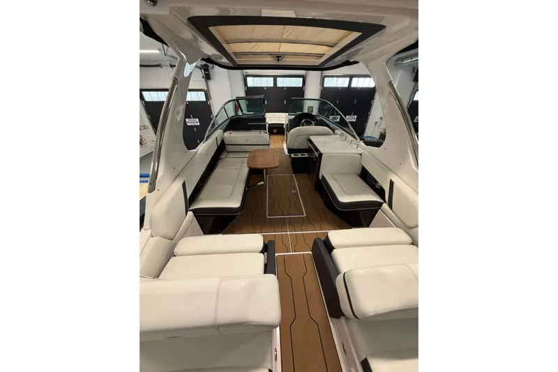  Yacht Photos Pics 2021 Regal 29 OBX boat interior with luxurious seating and wooden flooring.