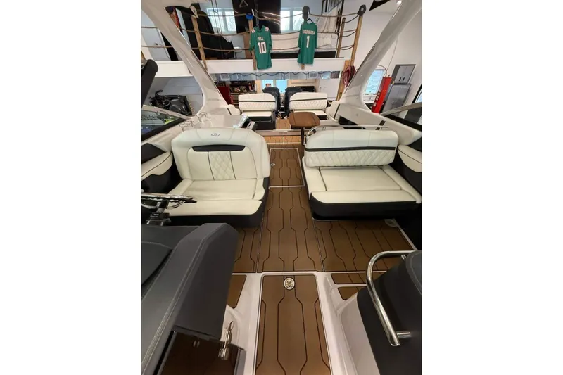  Yacht Photos Pics 2021 Regal 29 OBX boat interior with luxurious seating and wood-style flooring.