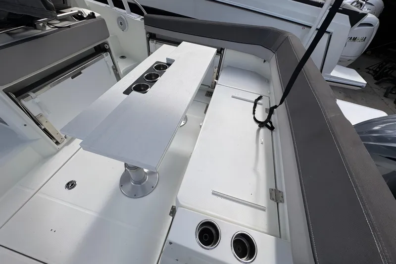  Yacht Photos Pics 2021 Jeanneau Leader 9.0 WA boat interior with seating and table setup.