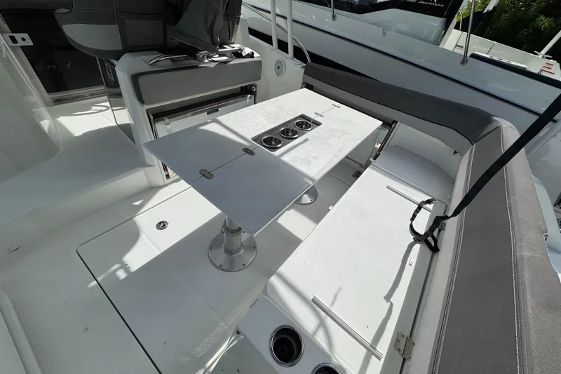  Yacht Photos Pics 2021 Jeanneau Leader 9.0 WA boat interior with seating and table setup.