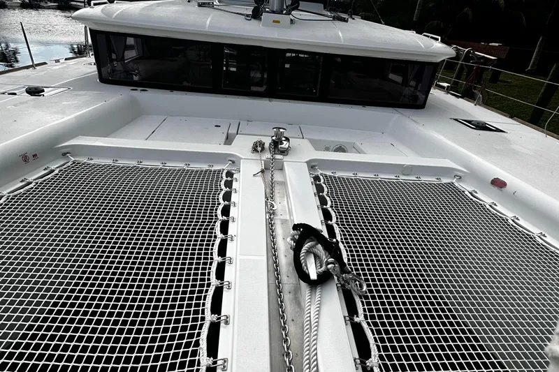 Cruisin Cajun Yacht Photos Pics 2017 Lagoon 450 F catamaran deck with netting and anchor chain.