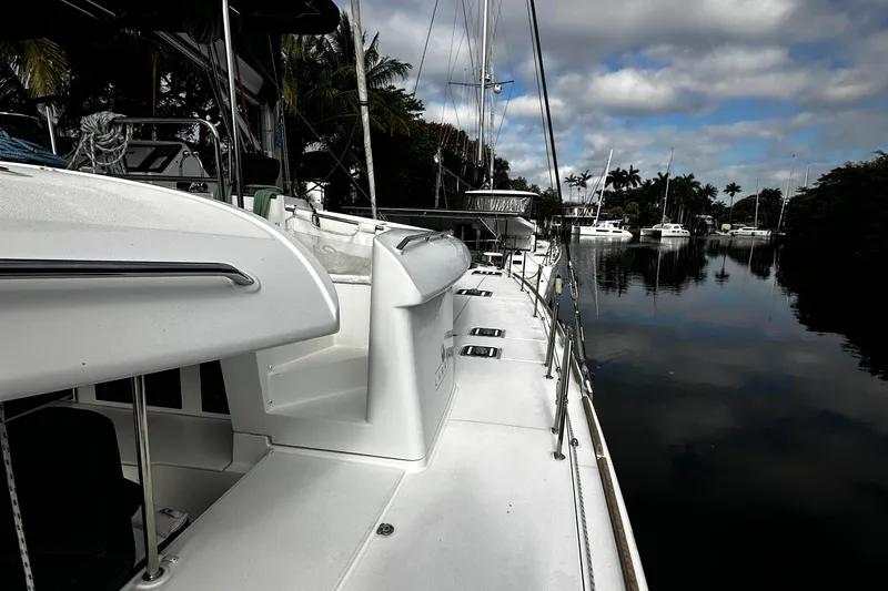 Cruisin Cajun Yacht Photos Pics 2017 Lagoon 450 F catamaran docked by a calm, reflective waterway.