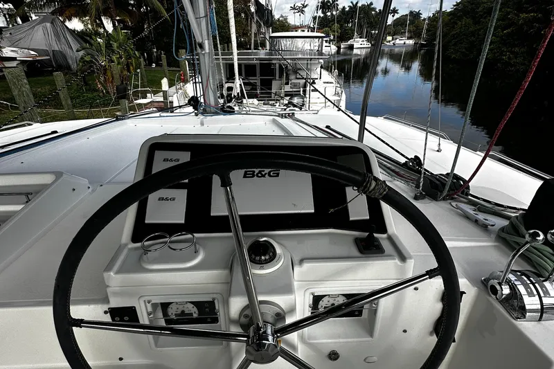 Cruisin Cajun Yacht Photos Pics Cockpit view of 2017 Lagoon 450 F catamaran with steering wheel and navigation equipment.