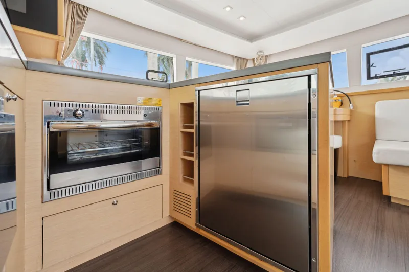 Cruisin Cajun Yacht Photos Pics Modern kitchen interior of 2017 Lagoon 450 F yacht with stainless steel appliances.