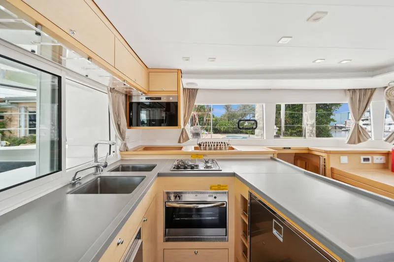 Cruisin Cajun Yacht Photos Pics Modern kitchen interior of 2017 Lagoon 450 F catamaran with sleek countertops and appliances.