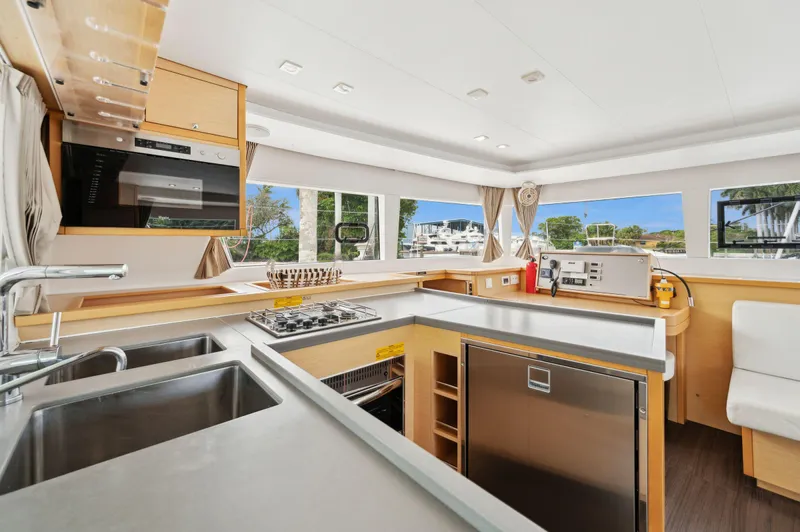 Cruisin Cajun Yacht Photos Pics Modern kitchen interior of 2017 Lagoon 450 F catamaran with stainless steel appliances.