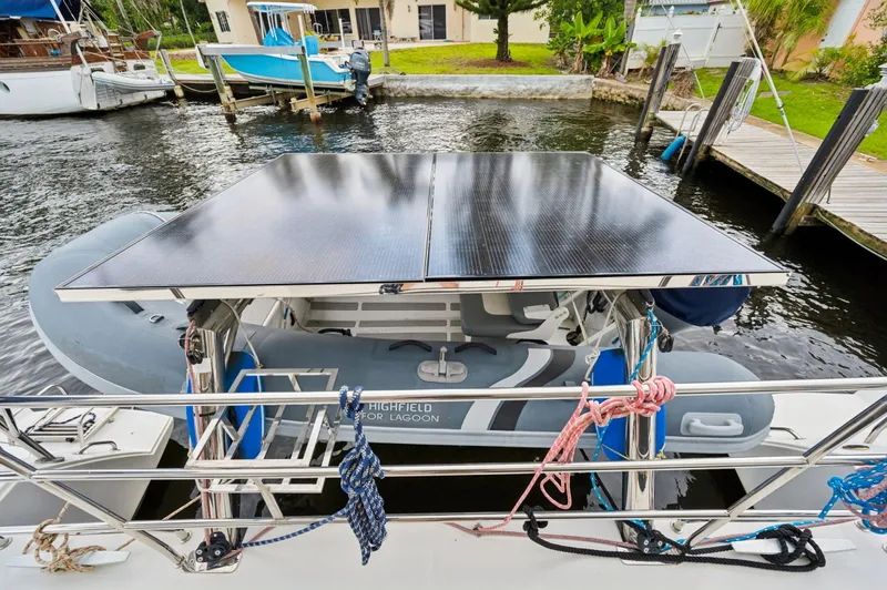 Cruisin Cajun Yacht Photos Pics Lagoon 450 F 2017 catamaran with solar panels and dinghy at dock.